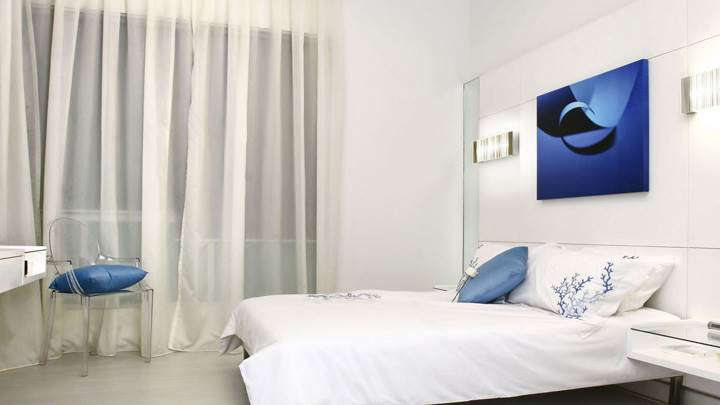 White Interior And White Bedsheet On Bed